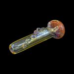 Glass cannabis pipe with iridescent bubbles and a speckled bowl, isolated on black.