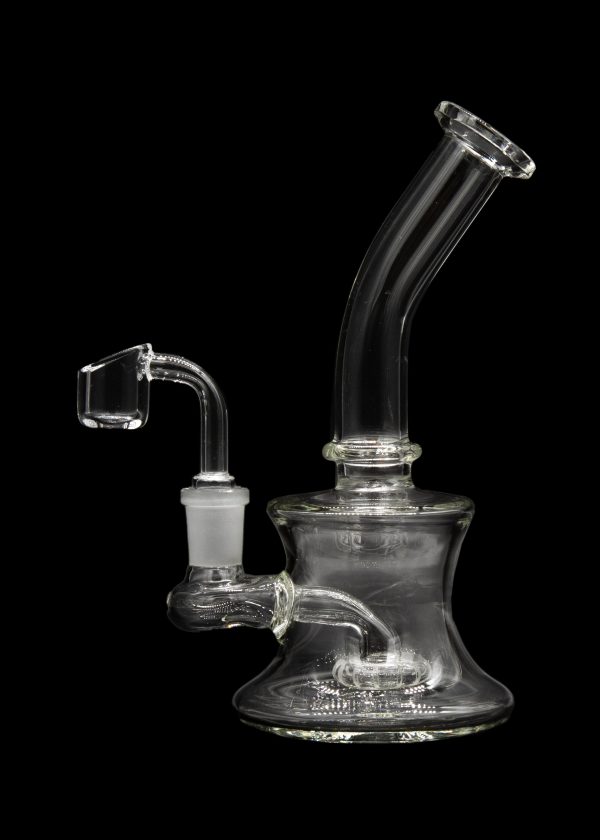 Clear glass dab rig with a quartz banger, isolated on a black background.