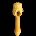 Golden glass pipe against a black background.