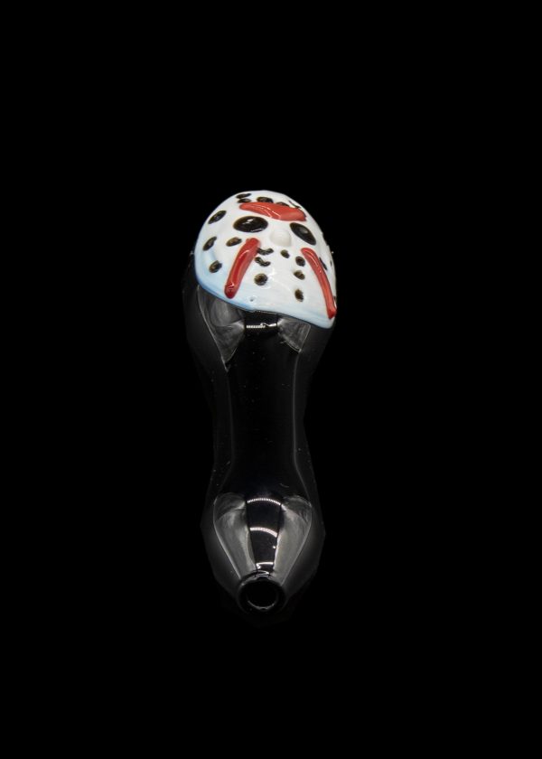 Glass cannabis pipe with colorful speckled mushroom-shaped bowl, isolated on black.