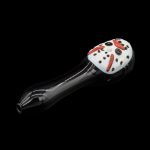 Glass pipe shaped like a ladybug with black and white spotted head and shiny black stem, isolated on a black background.