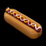 Glass pipe shaped like a hot dog with mustard and ketchup.