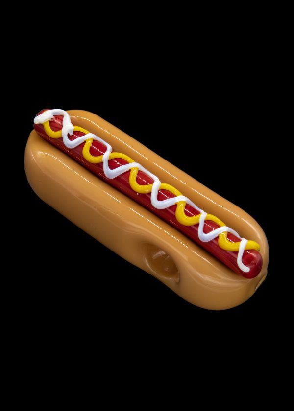 Glass pipe shaped like a hot dog with mustard and ketchup.