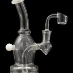 Clear glass dab rig with a quartz banger, studio shot on a black reflective surface.
