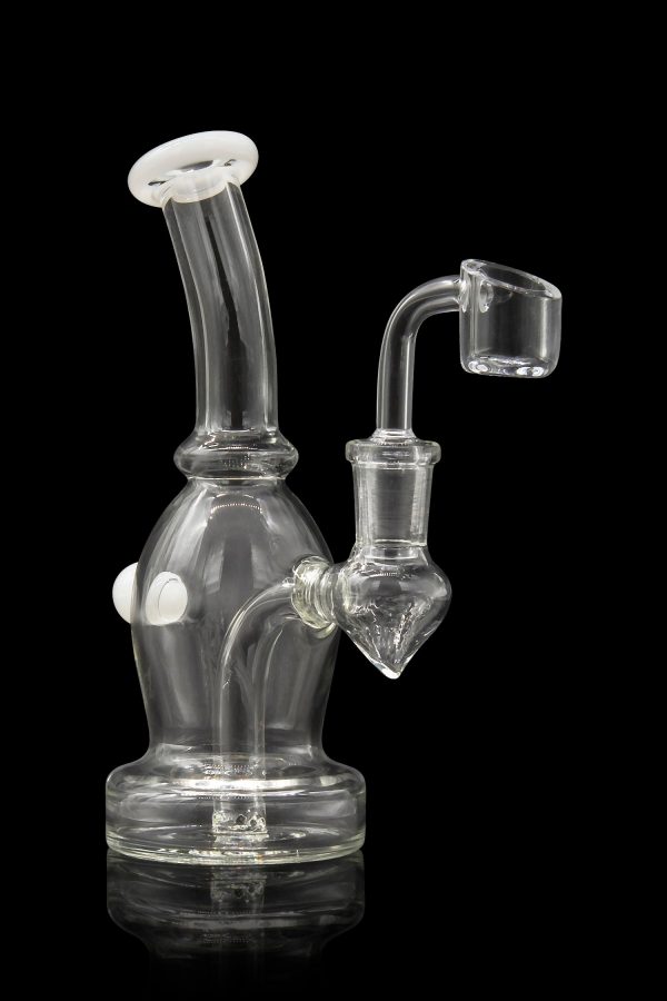 Clear glass dab rig with a quartz banger, isolated on a black background.
