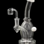 Clear glass dab rig with a quartz nail, isolated on black.