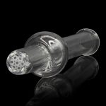 Glass cannabis pipe with intricate honeycomb filtration, reflected on a dark surface.