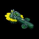 Hand-blown glass cannabis pipe shaped like a frog with yellow bubble details, isolated on a black background.