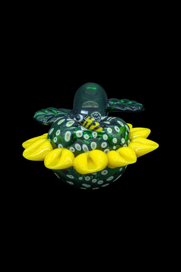 A vibrant green and yellow glass cannabis water pipe shaped like a turtle, isolated on a black background.