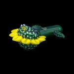 Hand-blown glass cannabis pipe shaped like a bee resting on a yellow flower.