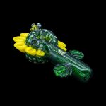 Hand-blown glass pipe shaped like a crocodile with vibrant green and yellow accents.