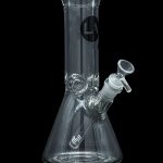 Clear glass bong with intricate design and ice catcher, isolated on a black background.