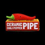 Red ceramic chili pepper pipe displayed in its packaging.