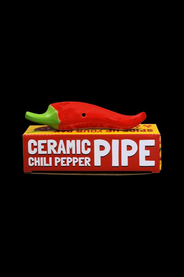 Red ceramic chili pepper pipe displayed in its packaging.
