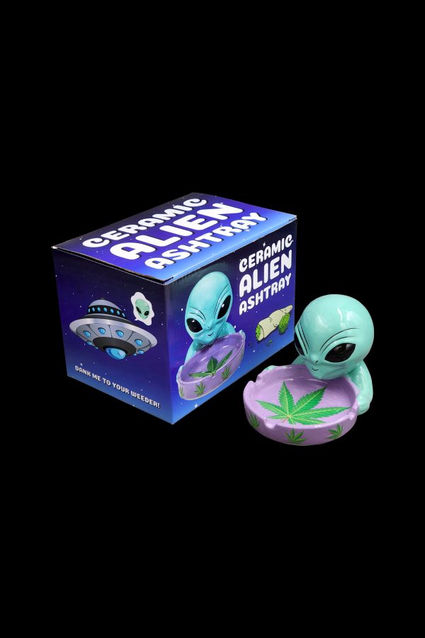 Ceramic alien ashtray with packaging, featuring a UFO and marijuana leaf design.