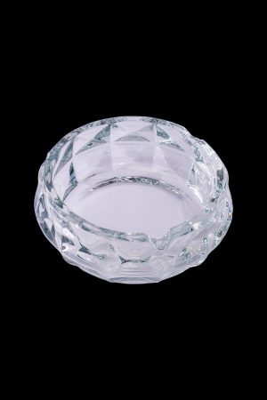 Clear glass ashtray with faceted design.