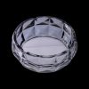 Clear glass ashtray with a geometric faceted design, isolated on a black background.
