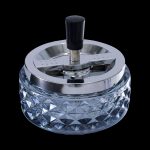 Crystal ashtray with a silver-tone spinning cover.