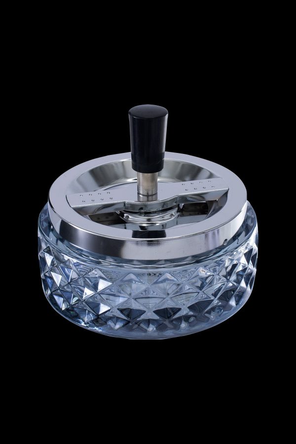 Crystal ashtray with a silver-tone spinning cover.