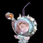 Hand-blown glass water pipe with a unique, organic shape, featuring copper-colored accents and crystalline formations, set against a black background.