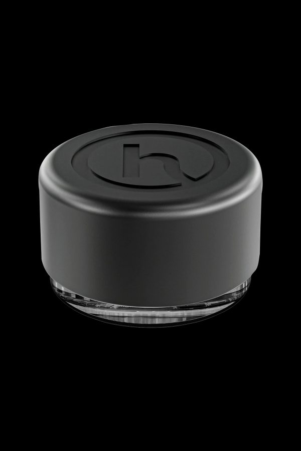 Black silicone cannabis concentrate container with clear base.