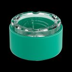 Green glass ashtray or stash jar with a textured, faceted lid.