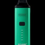 Green XMAX V3 Pro portable vaporizer with temperature settings displayed.