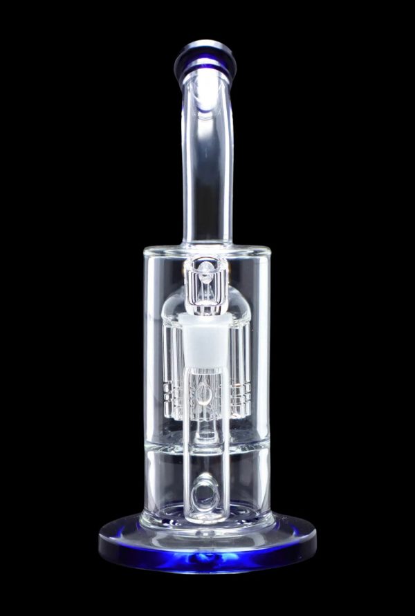 Clear glass dab rig with intricate percolators, illuminated with blue light against a black background.