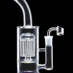 Glass rig with intricate percolator and quartz nail.