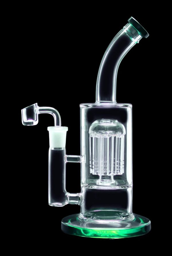 Clear glass water pipe (rig) with intricate perc filtration, featuring a green base and quartz nail.