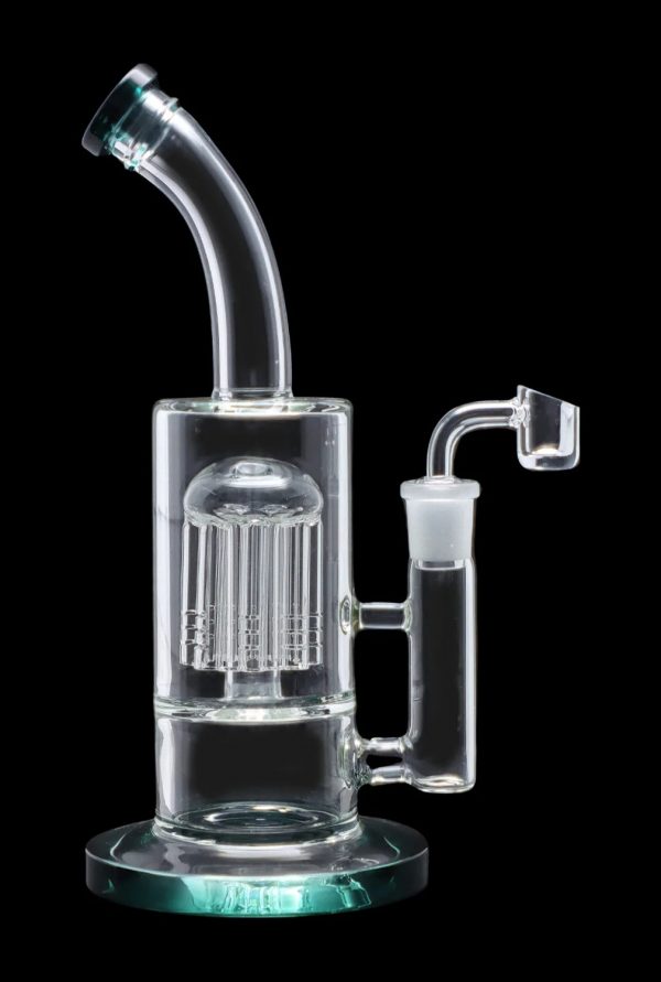 Clear glass water pipe (rig) with a perc filtration system and a quartz nail for dabbing cannabis concentrates.