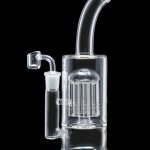 Clear glass bubbler with intricate perc diffusion and turquoise accents, isolated on black.
