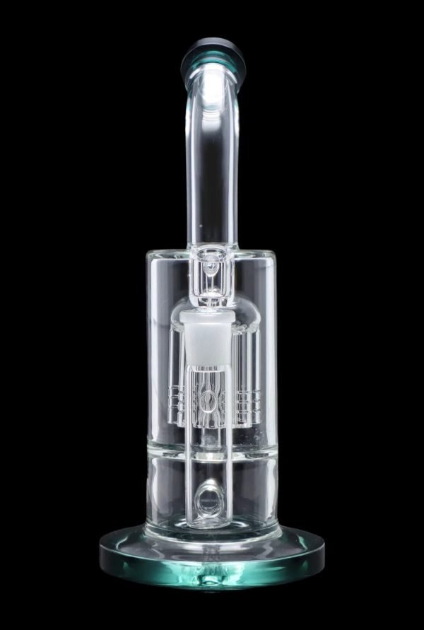 Clear glass dab rig with intricate percolator, isolated on black.
