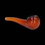 Amber glass pipe for smoking cannabis, isolated on a black background.