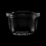 Clear glass dab dish isolated on black.
