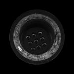 Overhead view of a glass pipe bowl filled with used cannabis.