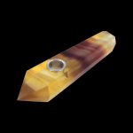 A golden-brown crystal pipe with a metal bowl, isolated on a black background.