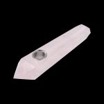 Rose quartz crystal pipe with a metal bowl, isolated on a black background.