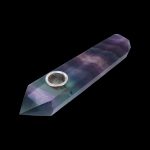 Iridescent crystal pipe against a black background.