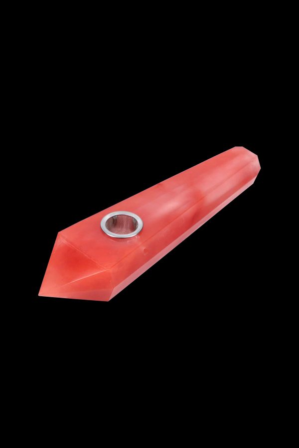 Red glass pipe with a metal screen, isolated on a black background.
