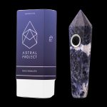 Blue sodalite gemstone pipe and packaging from Astral Project, displayed on a black background.