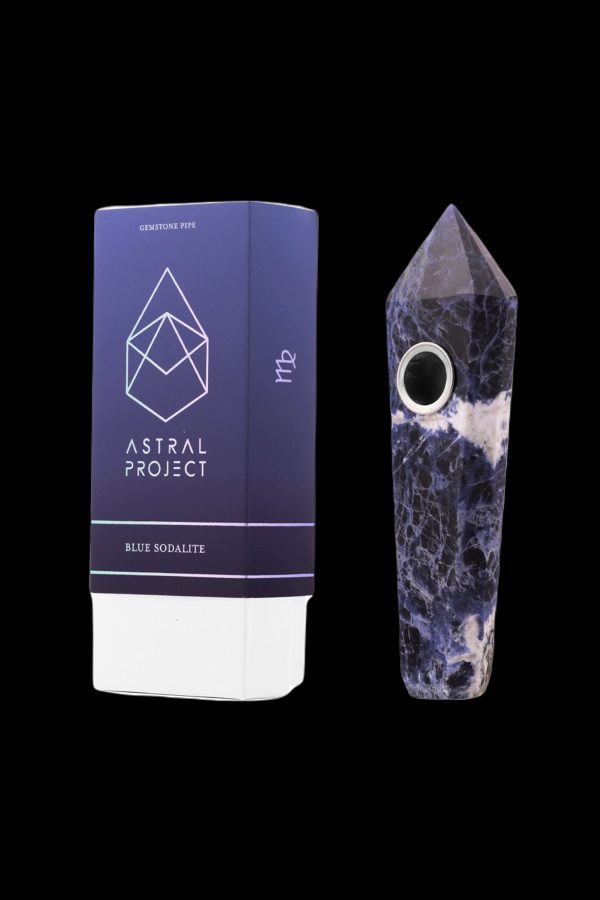 Blue sodalite gemstone pipe and packaging from Astral Project, displayed on a black background.