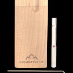 Wooden dugout one-hitter with glass smoking pipe and cleaning tool, branded “Canada Puffin.”
