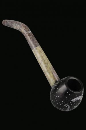A side view of the Carved Stone Pipe with OM Symbol, showing its smooth, curved shape and detailed carving.