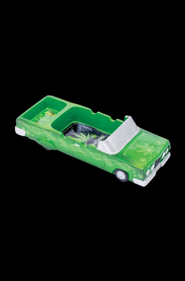 A detailed side view of the Cheech & Chong 50th Anniversary Lowrider Ashtray, showcasing its vintage car-inspired design.