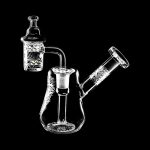 The Compact Travel Etched Dab Rig Set is displayed in a close-up, angled view, showcasing its etched glass details and compact size.