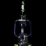 Blue glass water pipe with green accents, studio shot on black background.