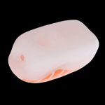 Peach-colored silicone carb cap for cannabis concentrates.