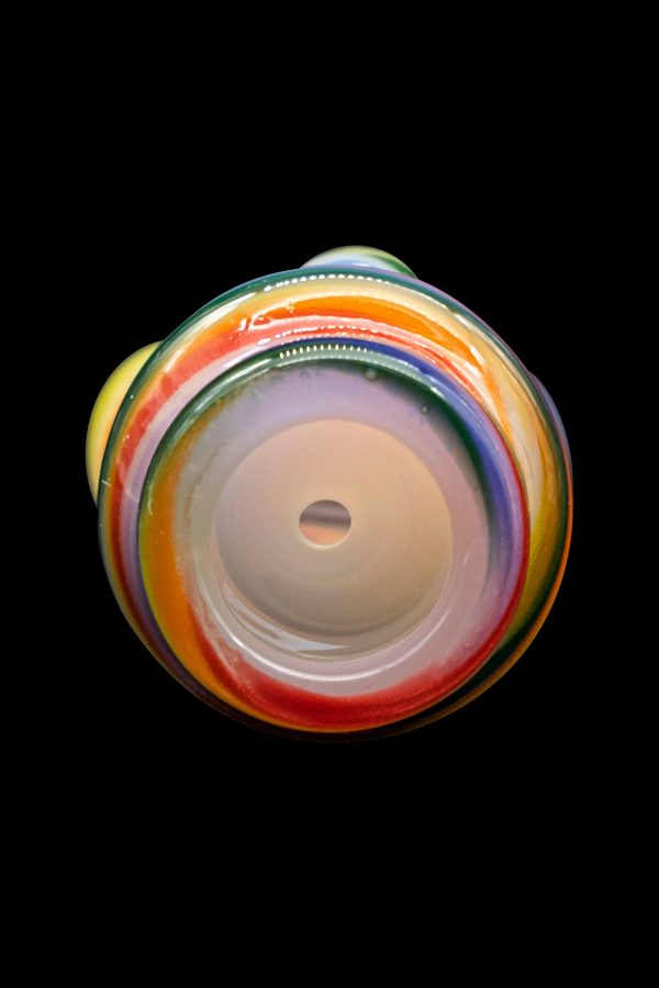 A colorful glass pipe against a black background.