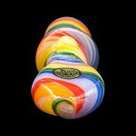 Colorful glass pipe with "JC Pipes - Made in USA" label against a black background.